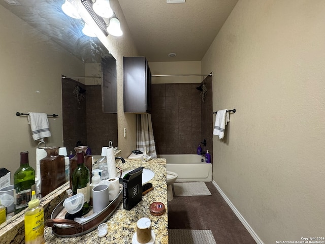 full bathroom featuring shower / bath combo with shower curtain, vanity, toilet, and a textured ceiling