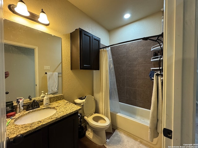 full bathroom featuring shower / bath combo, vanity, and toilet