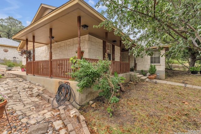 view of property exterior featuring covered porch