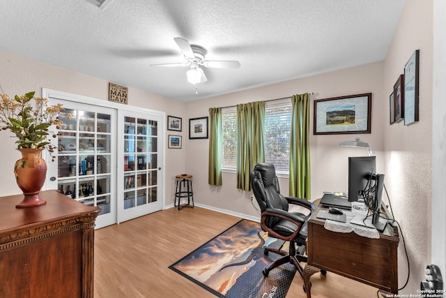 office area featuring light hardwood / wood-style floors, ceiling fan, and a textured ceiling