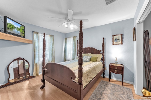 bedroom with ceiling fan and light hardwood / wood-style flooring