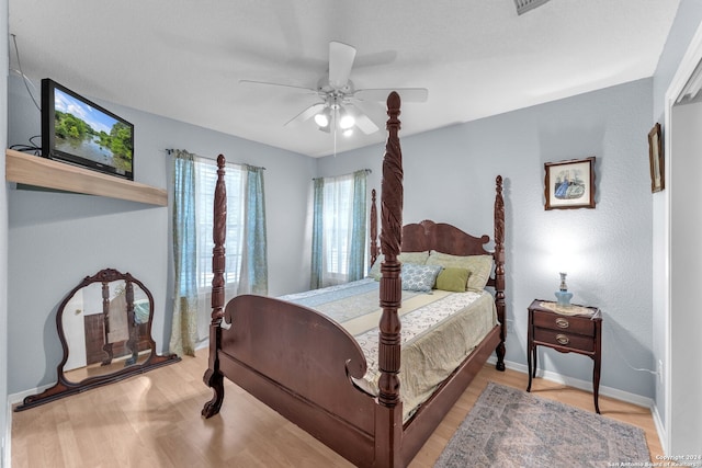 bedroom with ceiling fan and light hardwood / wood-style flooring