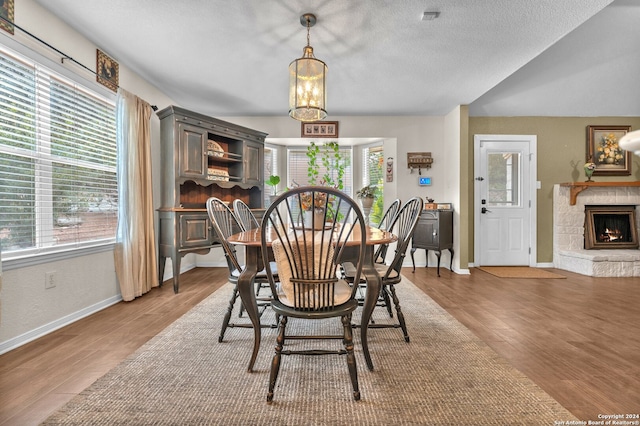 dining space with an inviting chandelier, hardwood / wood-style floors, and plenty of natural light