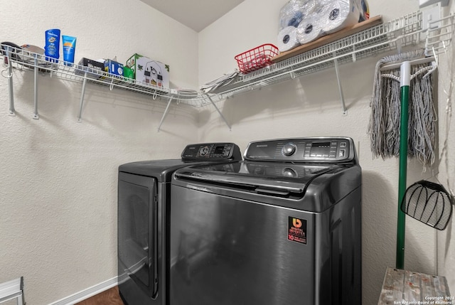 washroom featuring wood-type flooring and washing machine and clothes dryer