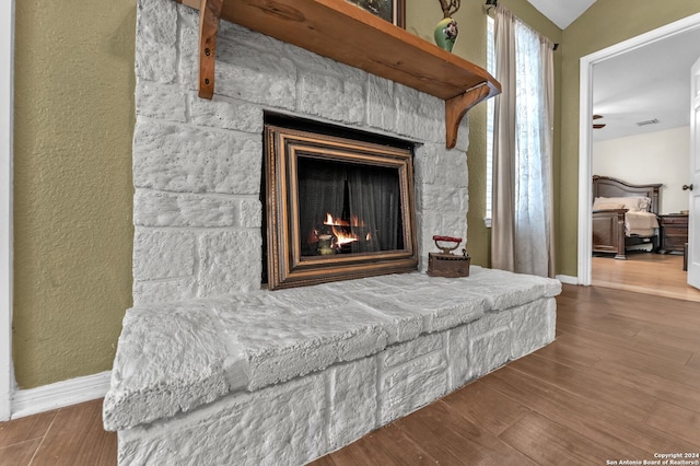 interior details featuring hardwood / wood-style floors and a fireplace