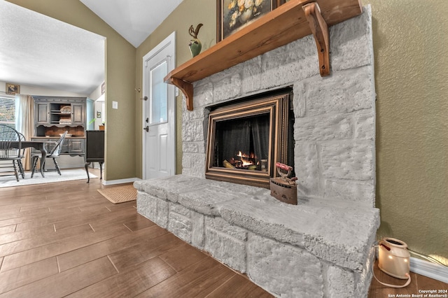 details featuring a stone fireplace and hardwood / wood-style flooring