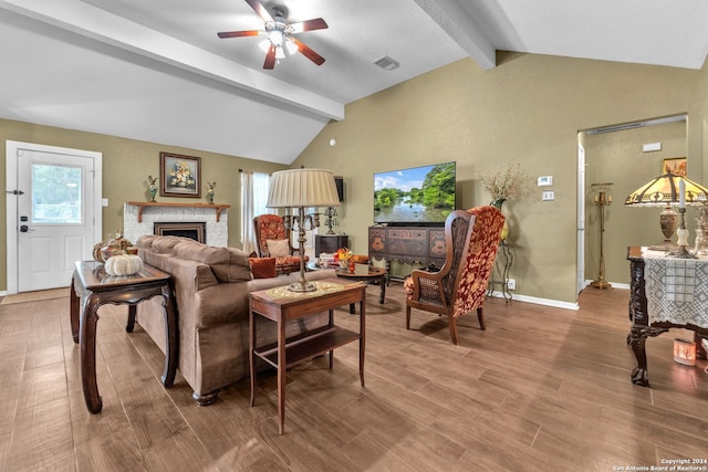 living room with hardwood / wood-style floors, vaulted ceiling with beams, and ceiling fan