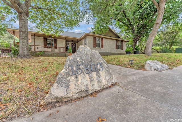 single story home featuring covered porch