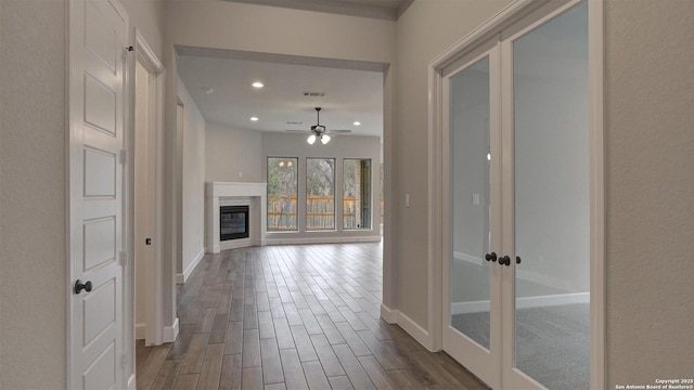 hall featuring french doors, baseboards, dark wood-style flooring, and recessed lighting