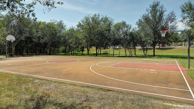 view of basketball court with a lawn