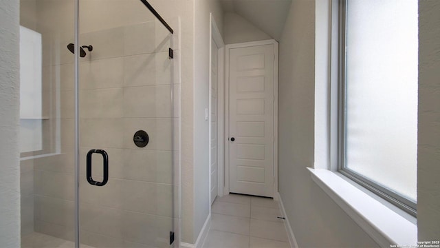 full bathroom with a shower stall, baseboards, and tile patterned floors