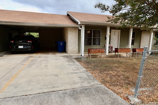 ranch-style home featuring a carport