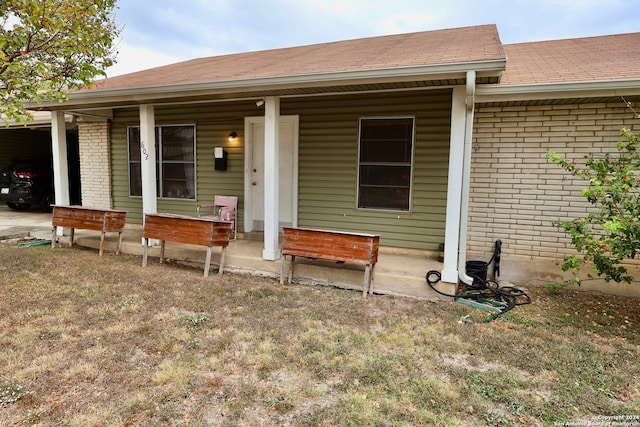 back of house featuring a porch