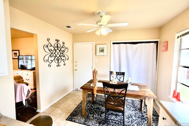 tiled office featuring ceiling fan