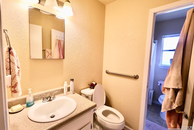 bathroom with tile patterned floors, vanity, and toilet