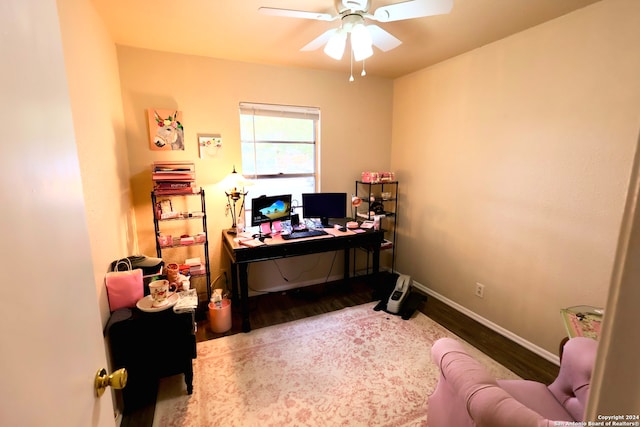 home office with light wood-type flooring and ceiling fan