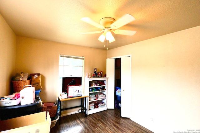 interior space featuring a textured ceiling, dark hardwood / wood-style flooring, ceiling fan, and a closet