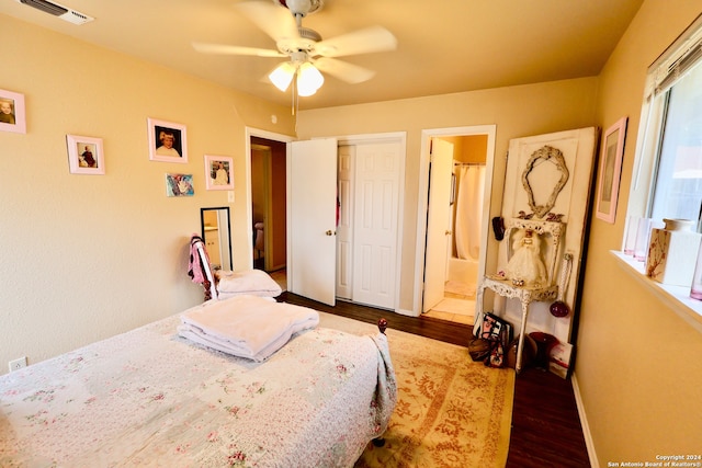 bedroom with ceiling fan, dark hardwood / wood-style floors, and ensuite bathroom