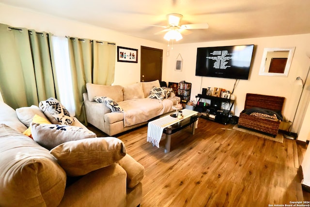 living room featuring ceiling fan and wood-type flooring