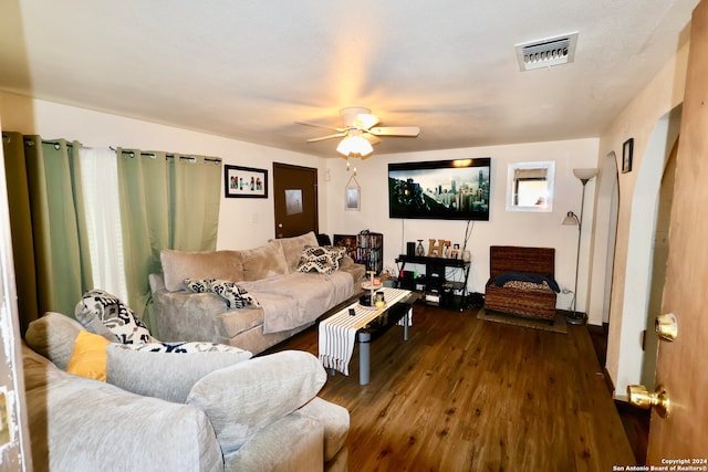 living room with dark hardwood / wood-style floors and ceiling fan