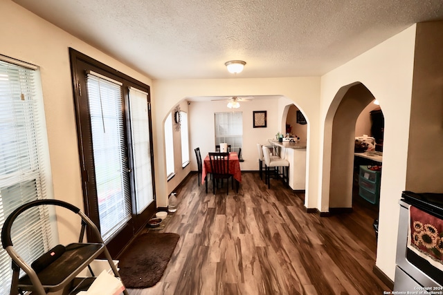 hallway featuring dark wood-type flooring and a textured ceiling