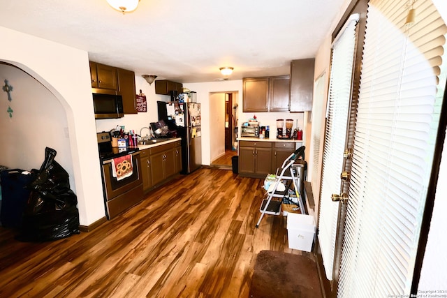 kitchen with stainless steel appliances, dark wood-type flooring, and sink