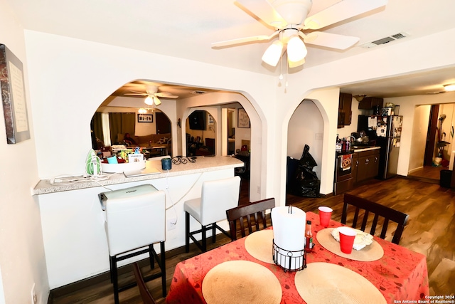 dining room featuring ceiling fan and dark hardwood / wood-style flooring