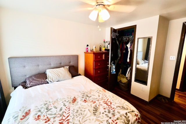 bedroom featuring dark wood-type flooring, ceiling fan, and a closet