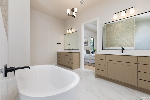 bathroom featuring vanity, a bath, and an inviting chandelier