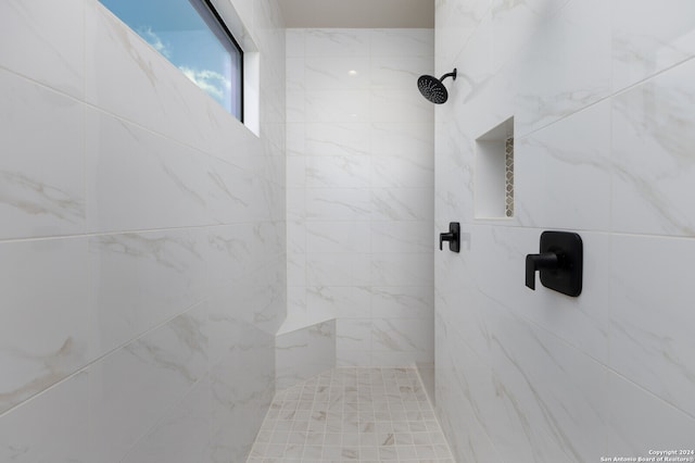 bathroom with tiled shower