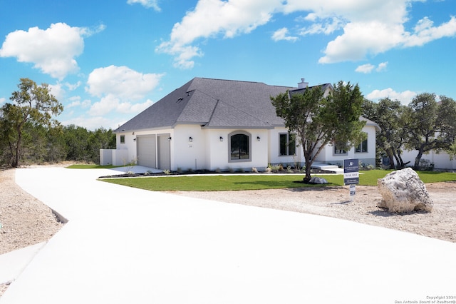 view of front facade with a front lawn and a garage