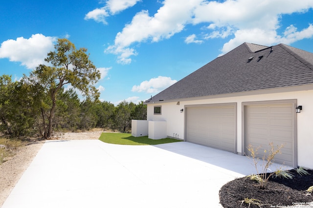 view of side of property with a garage