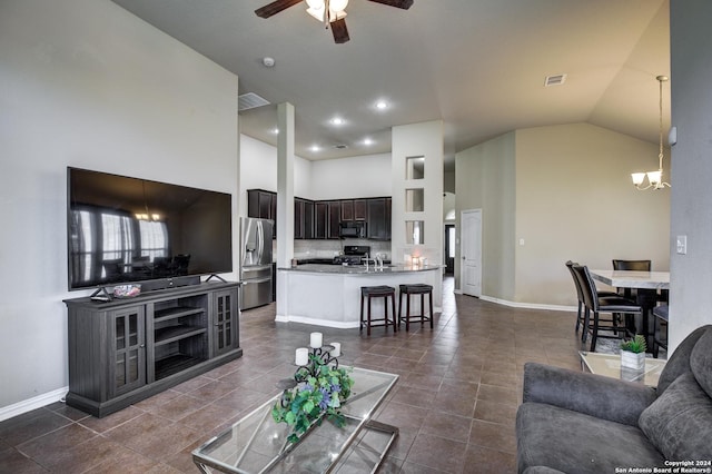 8811 Falcon Park, Converse, TX 78109 - living area featuring high vaulted ceiling, a ceiling fan, dark tile patterned flooring, baseboards, and a chandelier