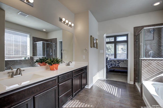 bathroom with a wealth of natural light, vanity, and independent shower and bath