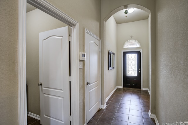 entryway featuring dark tile patterned floors