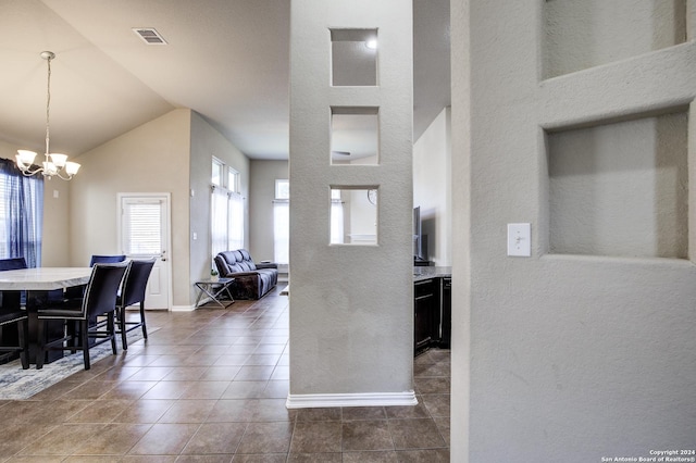 8811 Falcon Park, Converse, TX 78109 - kitchen featuring a chandelier, vaulted ceiling, a textured wall, baseboards, and dark tile patterned flooring