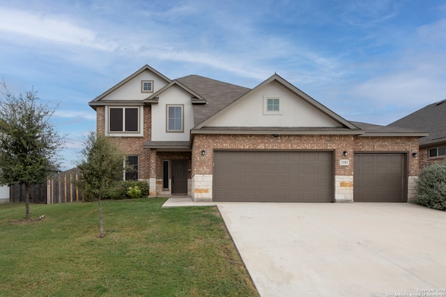 view of front facade featuring a front yard and a garage