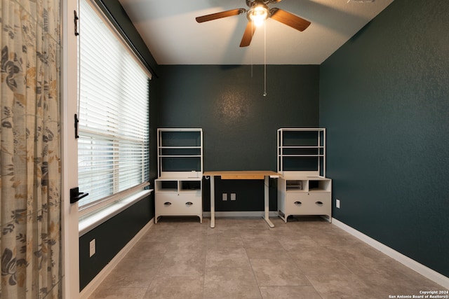 tiled office space featuring ceiling fan