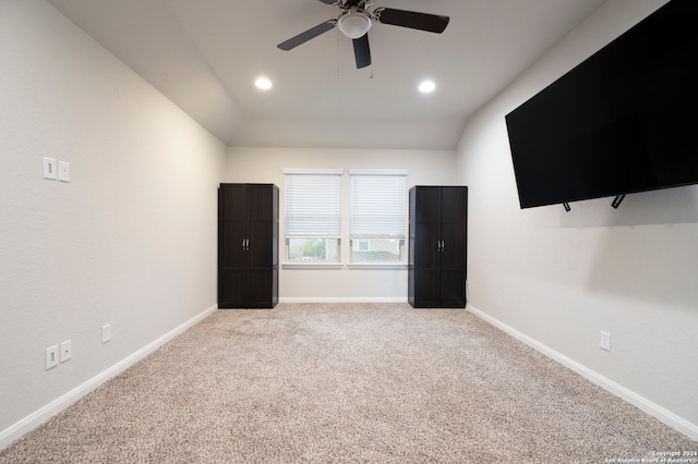 unfurnished bedroom featuring lofted ceiling, light carpet, and ceiling fan