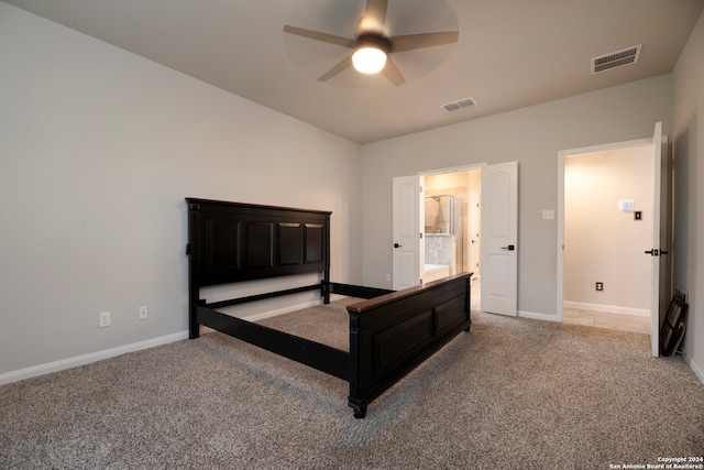 carpeted bedroom featuring ceiling fan and ensuite bath