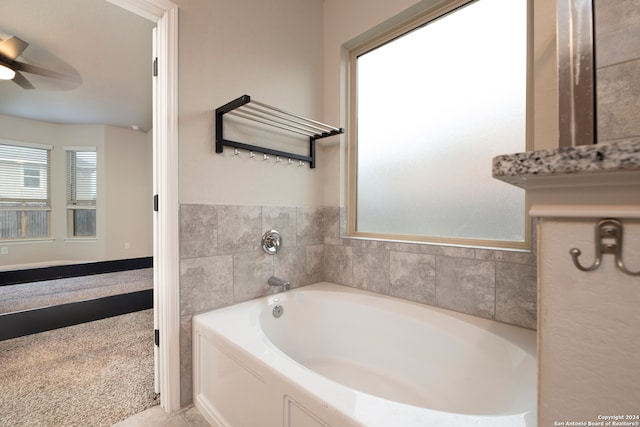 bathroom featuring a tub to relax in and ceiling fan