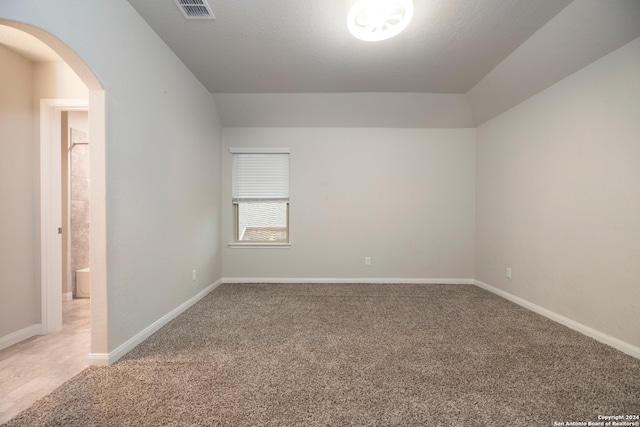 empty room with carpet and a textured ceiling