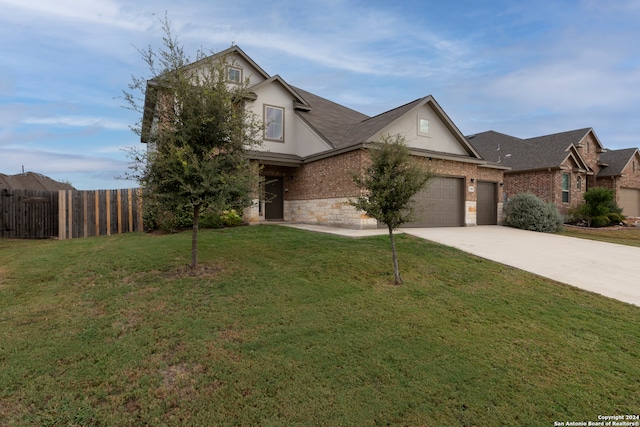 view of front of home featuring a garage and a front lawn