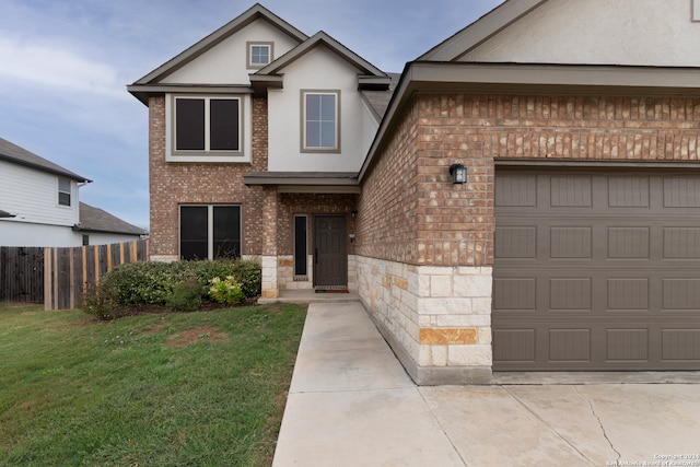 view of front facade with a garage and a front yard