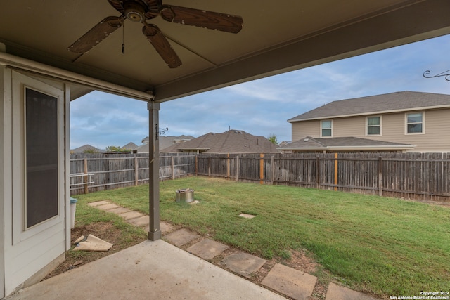 view of yard featuring ceiling fan and a patio