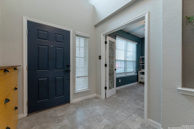 entryway with light tile patterned floors