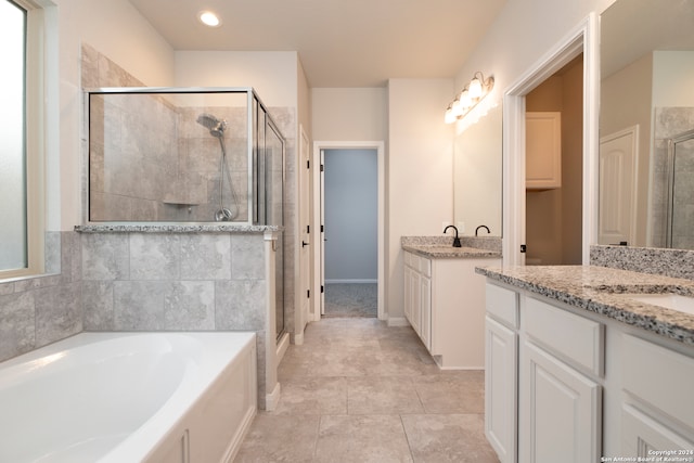 bathroom with shower with separate bathtub, tile patterned floors, and vanity