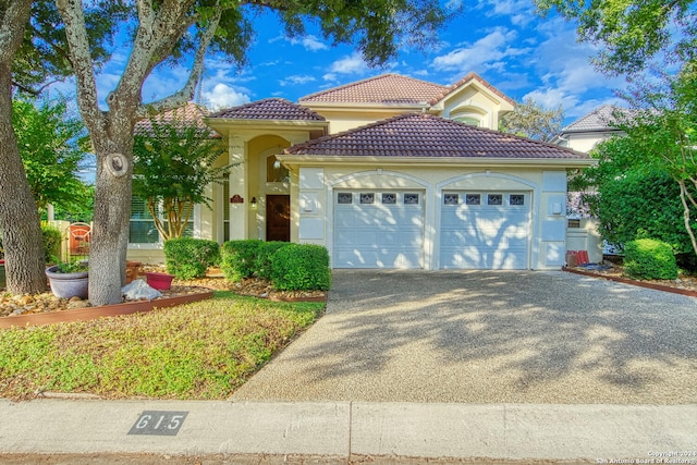 mediterranean / spanish-style house with a garage