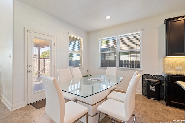 tiled dining space with a healthy amount of sunlight