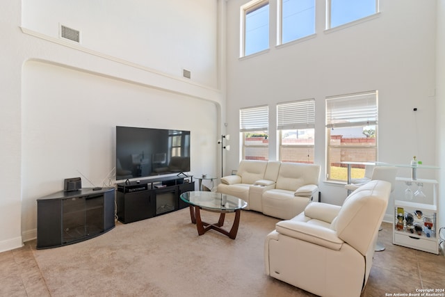 tiled living room with a towering ceiling